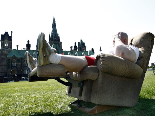 An Ottawa man, who cannot be identified, whose obesity played a factor in his losing custody of his children sits on his La-Z-boy on Parliament Hill to protest the ruling.